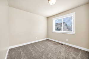 Carpeted empty room with baseboards