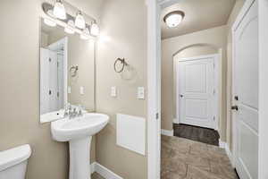 Bathroom with toilet and light tile patterned floors