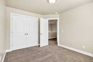 Unfurnished bedroom with carpet flooring and a closet