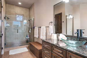 Full bath featuring a stall shower, vanity, light tile patterned floors, and recessed lighting