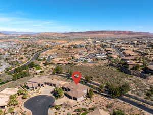 Aerial view of property's location featuring mountains and nearby suburban area
