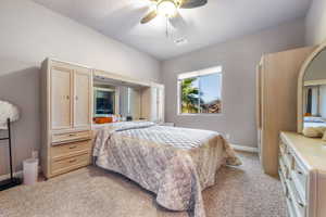 Bedroom with light colored carpet and ceiling fan