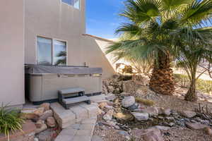 View of patio with a hot tub
