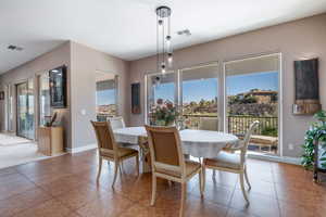 Dining area with baseboards and light tile patterned floors
