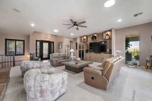 Living area featuring a ceiling fan and arched walkways