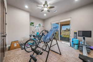 Exercise area featuring a ceiling fan, recessed lighting, carpet floors, and plenty of natural light