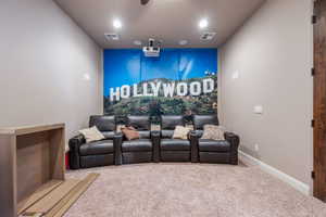 Home theater featuring carpet flooring and recessed lighting
