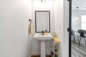 Bathroom featuring wood finished floors and baseboards