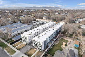 Bird's eye view of a mountainous background and apartment complex / building