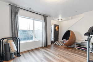 Foyer with light wood-style floors and a textured ceiling