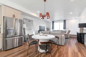 Dining area with dark wood-type flooring and recessed lighting