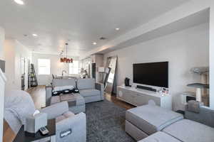 Living area featuring dark wood-type flooring and recessed lighting