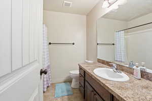 Full bath with vanity, a shower with curtain, and light tile patterned flooring