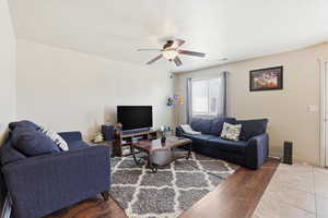 Living area with wood finished floors and ceiling fan
