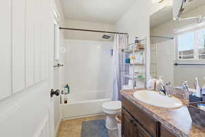 Bathroom with vanity and shower / bath combo with shower curtain