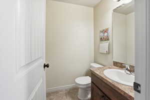 Half bath featuring vanity and light tile patterned floors