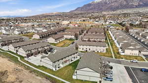 Aerial view of property's location featuring a mountain backdrop and nearby suburban area