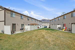 Rear view of house with a mountain view and a patio area