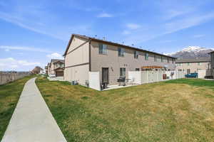 Rear view of property featuring a mountain view and a patio