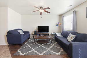 Living room with ceiling fan and baseboards