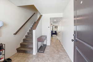 Stairway featuring recessed lighting, tile patterned floors, and a ceiling fan
