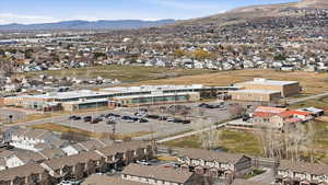 Aerial overview of property's location with nearby suburban area and a mountain backdrop