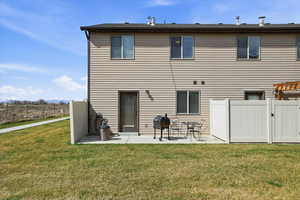 Back of house featuring a patio and a gate