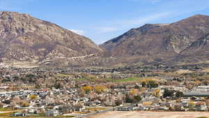 View of mountain backdrop featuring nearby suburban area