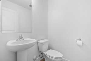 Bathroom featuring toilet and baseboards
