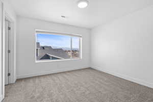 Unfurnished room with light carpet and baseboards