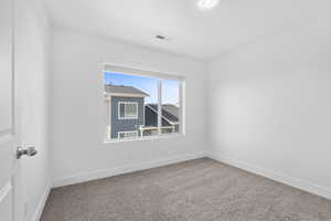 Spare room with carpet floors and baseboards