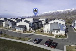 Aerial perspective of suburban area featuring a mountainous background