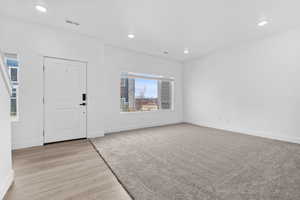 Foyer entrance with recessed lighting and light wood-style floors