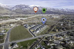 Aerial overview of property's location with a mountain backdrop and nearby suburban area