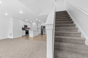 Stairs featuring carpet floors and recessed lighting