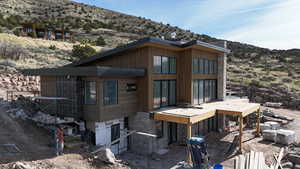 Rear view of property featuring a mountain view