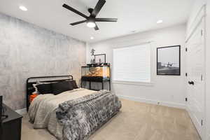 Bedroom featuring light carpet, a ceiling fan, and recessed lighting
