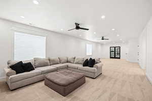 Living area with carpet, recessed lighting, dual ceiling fans