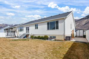 Rear view of house featuring a mountain view, a patio area