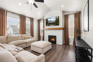 Living room featuring a ceiling fan, luxury vinyl flooring LVP, plenty of natural light, a brick fireplace, and recessed lighting