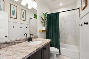 Full bathroom with vanity, shower / bathtub combination with curtain, and recessed lighting