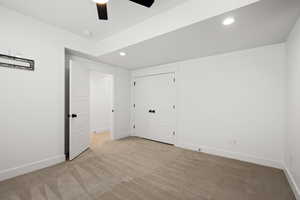 bedroom featuring light carpet, ceiling fan, a closet, and recessed lighting