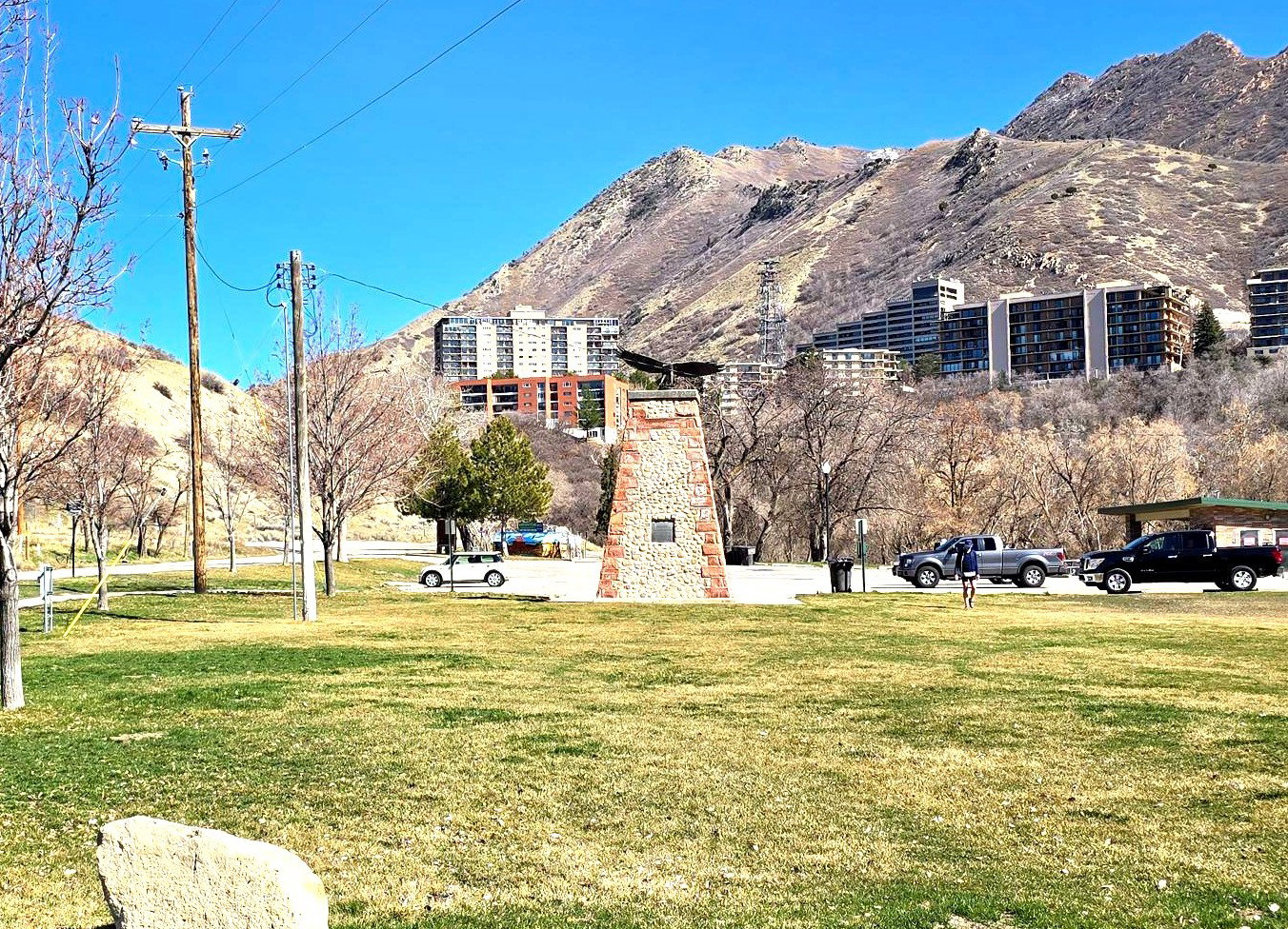 View of subject building (red brick) from Emigration Canyon Park.the