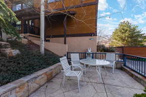 View of patio with outdoor dining area and a deck