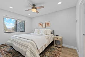 Bedroom featuring wood finished floors, a ceiling fan, and recessed lighting