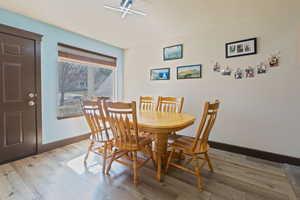 Dining space with light wood-style floors and baseboards