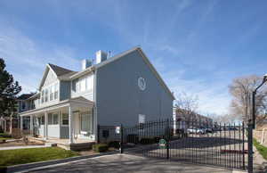 View of side of property featuring covered porch, a gate, and a chimney