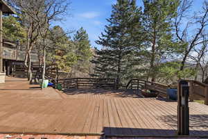 Deck featuring view of scattered trees