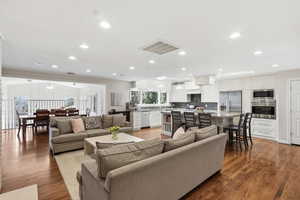 Living room with dark wood-style flooring, recessed lighting, and a ceiling fan