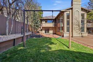 Rear view of house with brick siding, french doors, a patio, and a chimney
